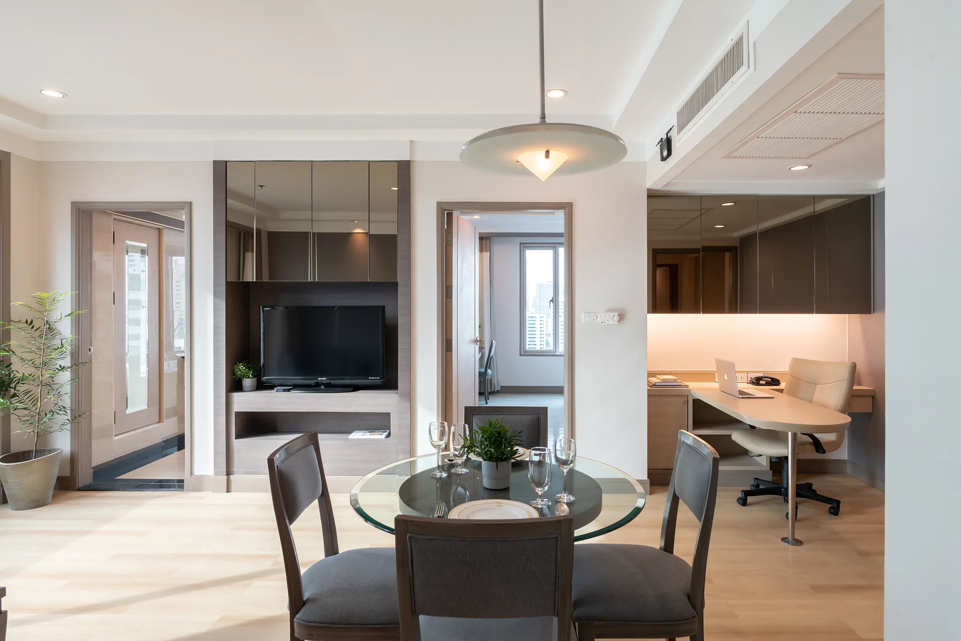 Interior of a 2-bedroom suite with kitchen at a hotel in Bangkok.