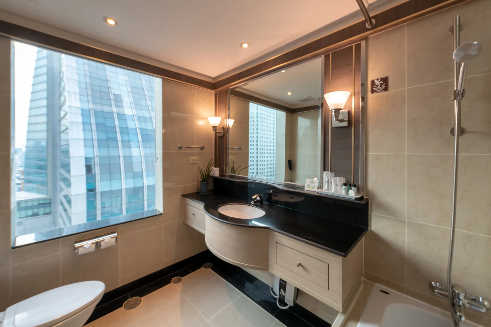 Bedroom in a two-bedroom suite with kitchen at a long-stay Sukhumvit hotel.