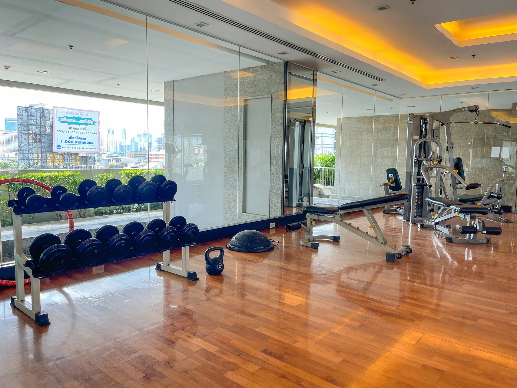A fitness center at a Bangkok hotel with modern exercise equipment.