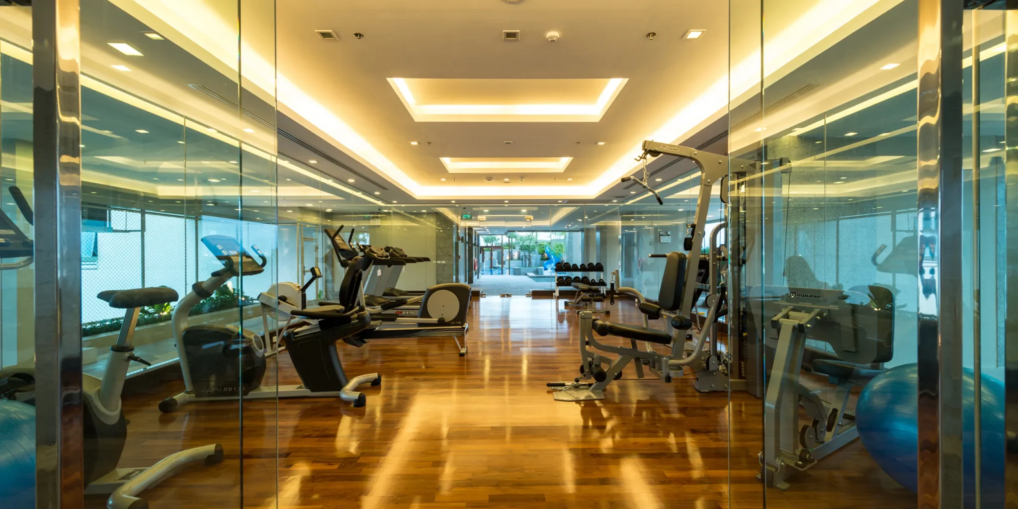The gym area at a Bangkok hotel with cardio and weight training machines.