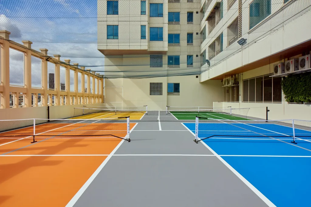 Pickleball and tennis court at a Bangkok hotel with shared sports area.