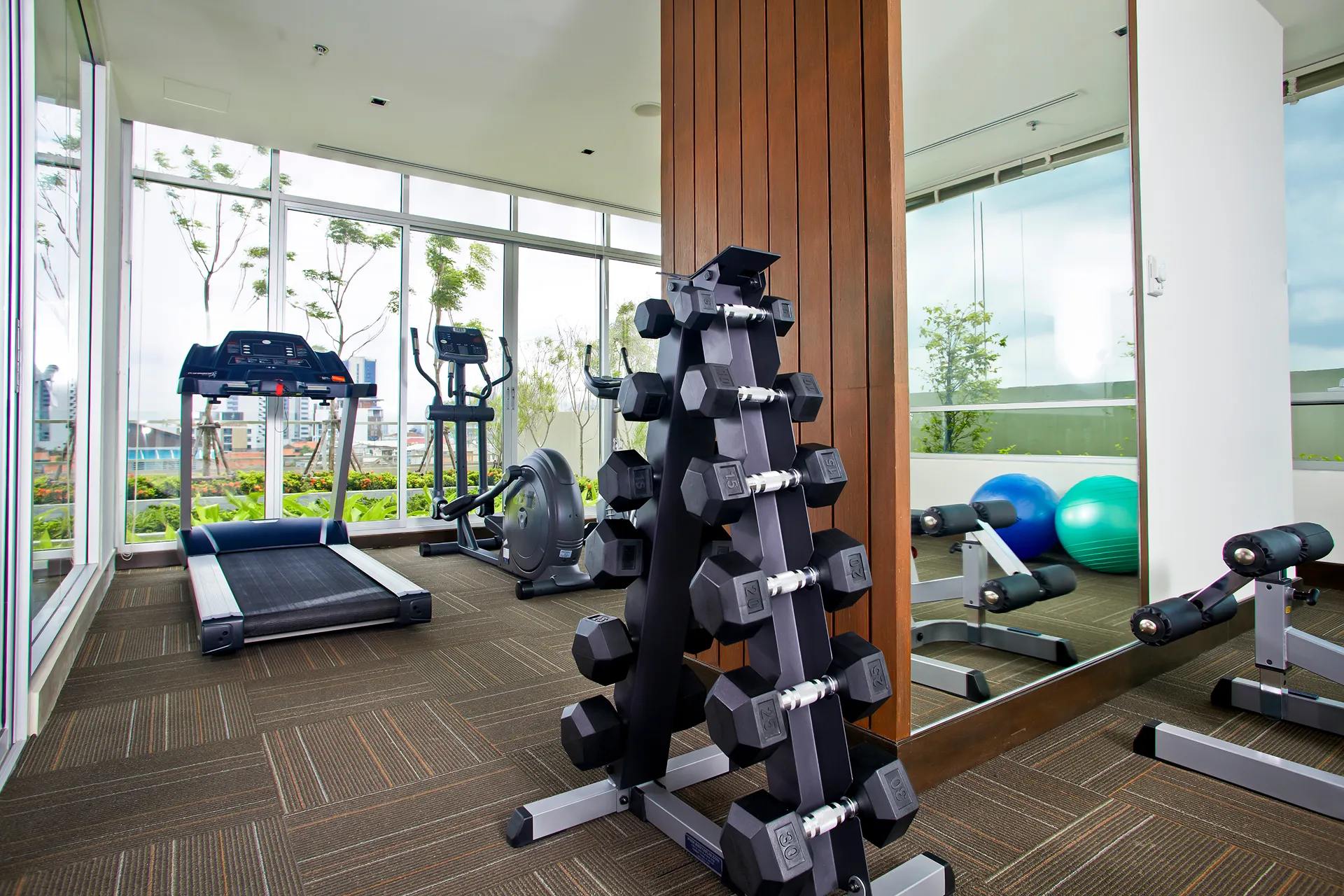 A fitness center at a hotel with Bangkok city atmosphere.