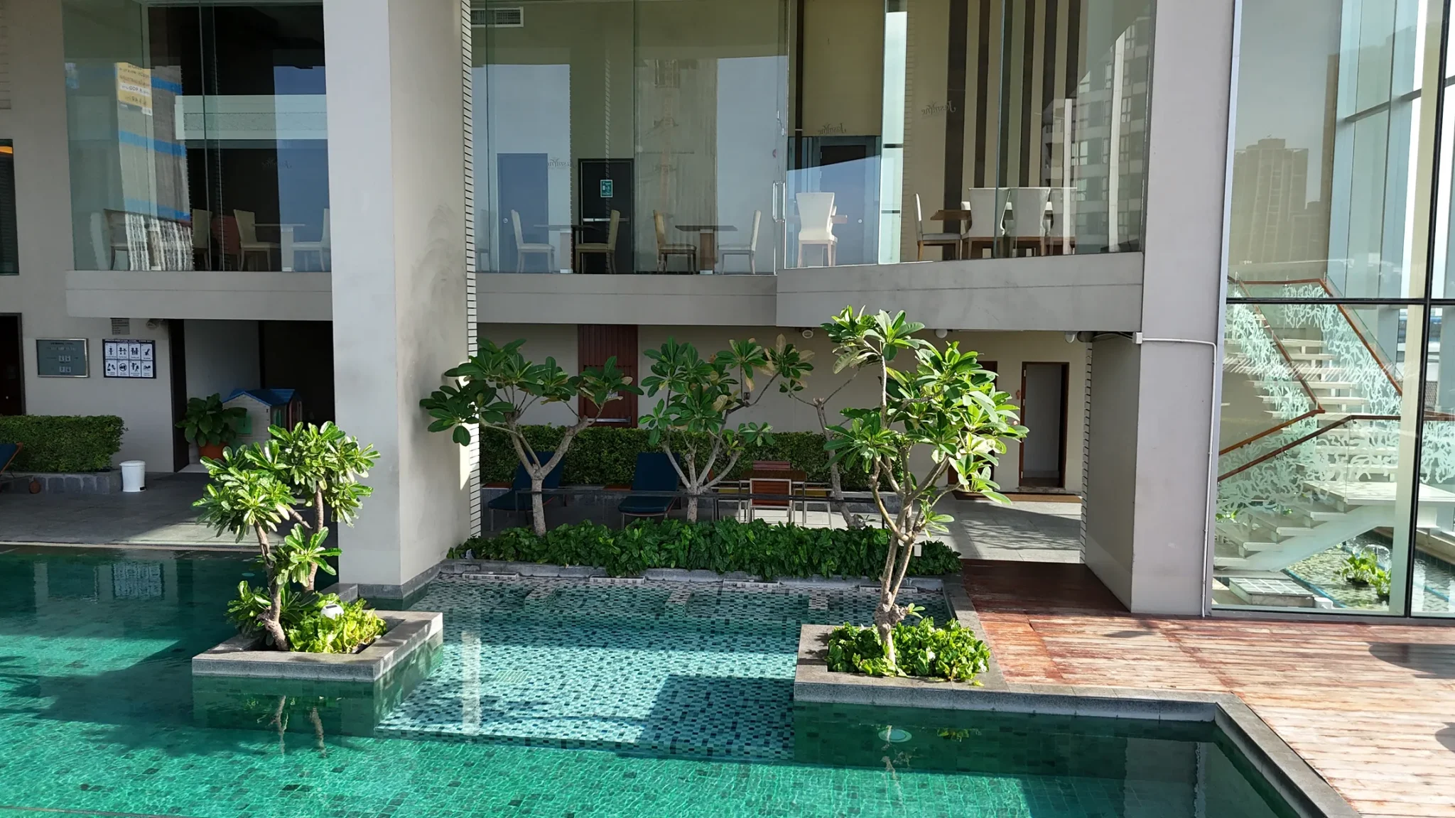 A swimming pool at a hotel with Bangkok city surroundings.