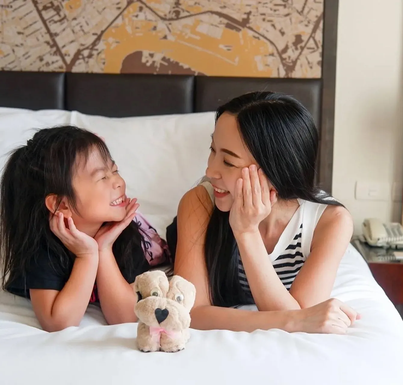 Mother and daughter enjoying a comfortable family long stay at a hotel in Bangkok.